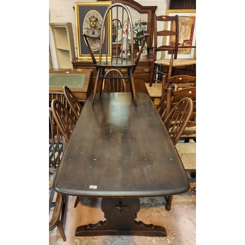 1002 - An Ercol style dining suite comprising refectory table and 6 (4+2) hoop and stick back dining chairs