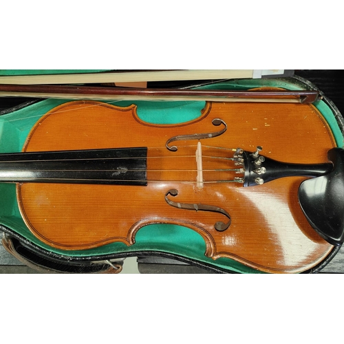 212 - A 20th Century violin with two bows in case.