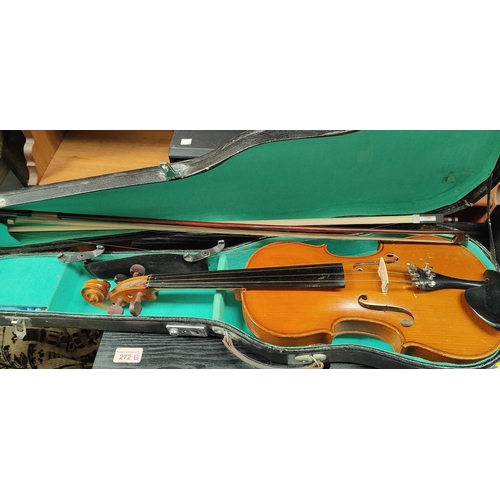 212 - A 20th Century violin with two bows in case.