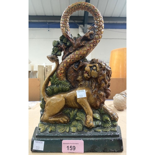 159 - A Victorian style cast iron door stop of a Lion fighting a Snake