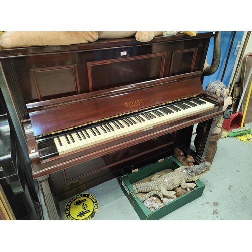 214 - An iron framed over strung upright piano in mahogany case by Rogers, London