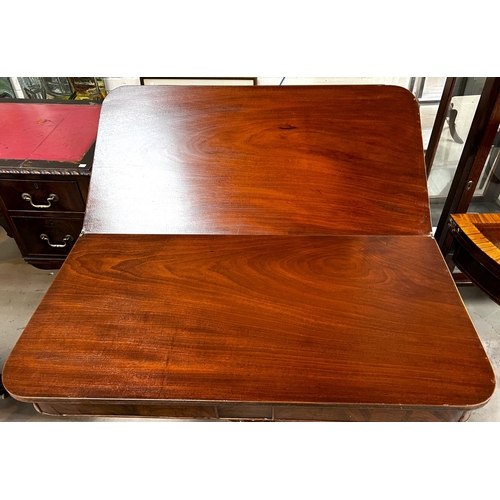 940 - A 19th Century mahogany fold over tea table on turned and ringed column, four splay feet and brass c... 