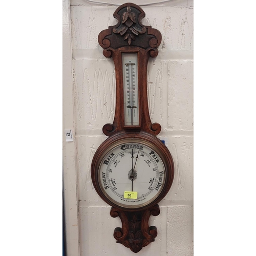 50 - A carved oak cased aneroid barometer with thermometer