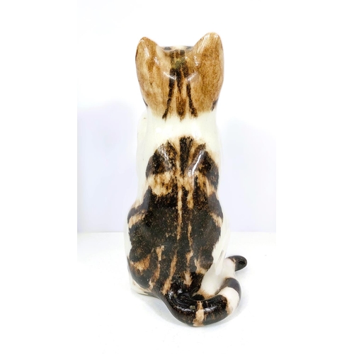 558 - A Winstanley cat, glass eyes, in 'begging' pose, signed, size 4