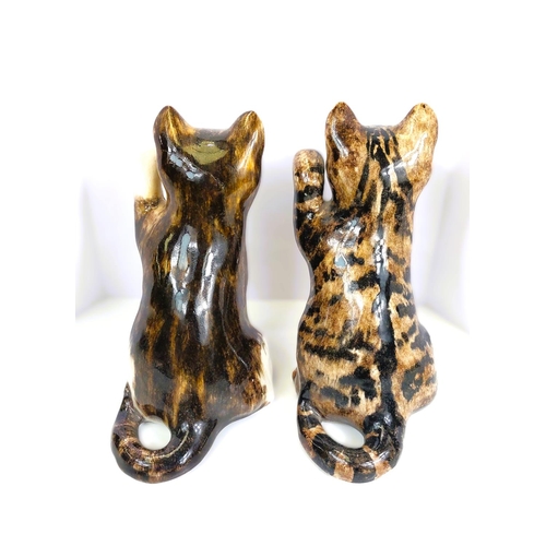 561 - Two Winstanley cats, glass eyes, both seated with one paw raised,  signed, size 3 (each a.f)