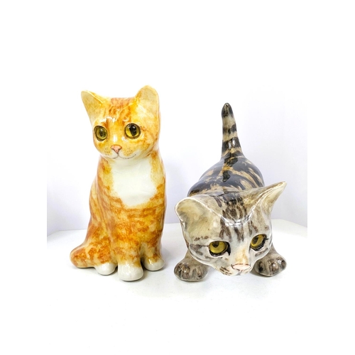 565 - 2 Winstanley cats, glass eyes, one seated, one playing, 1 x size 2, 1 x size 3, signed.