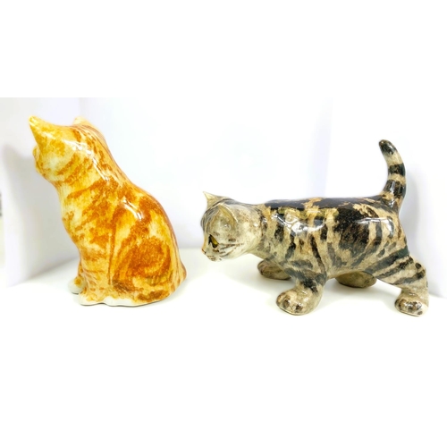 565 - 2 Winstanley cats, glass eyes, one seated, one playing, 1 x size 2, 1 x size 3, signed.