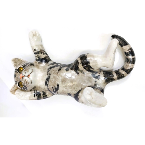 566 - A Winstanley cat, glass eyes, lying on its back, size 4 (arm a.f. but present); A Winstanley cat, gl... 