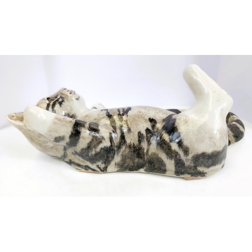 566 - A Winstanley cat, glass eyes, lying on its back, size 4 (arm a.f. but present); A Winstanley cat, gl... 