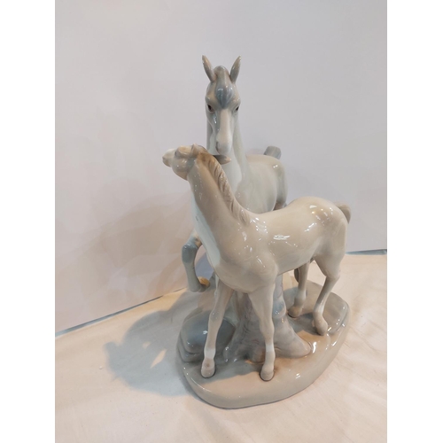 596 - A large Lladro style group of horse and foal.