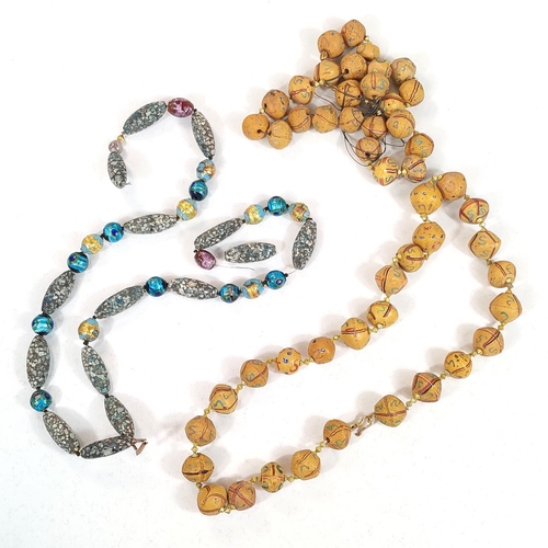 666 - Three Asian bead necklaces, with stones, with carved details and coloured beads etc.