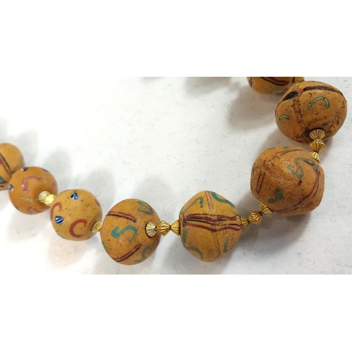 666 - Three Asian bead necklaces, with stones, with carved details and coloured beads etc.