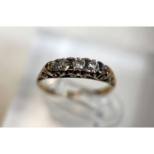 681 - A Victorian child size ring with unmarked yellow metal shank with 5 old cut diamonds in ornate split... 