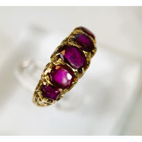 683 - A yellow metal dress ring set with 5 graduating rubies in the Victorian style, split shank setting, ... 