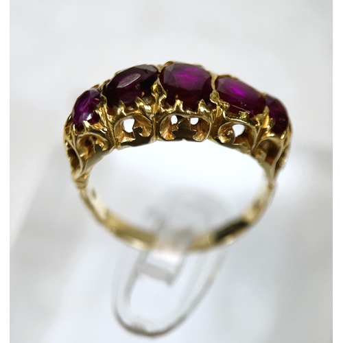 683 - A yellow metal dress ring set with 5 graduating rubies in the Victorian style, split shank setting, ... 