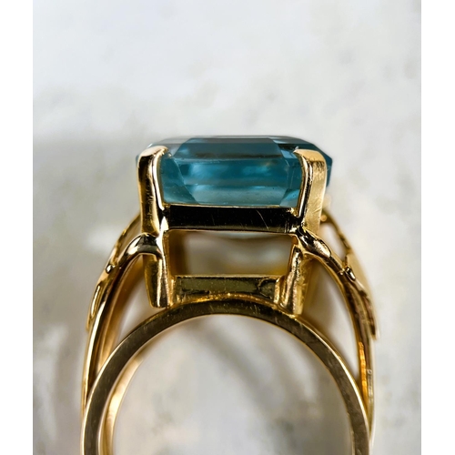 684 - A 1970's yellow metal dress ring with a large square cushion cut aquamarine colour stone in raised s... 