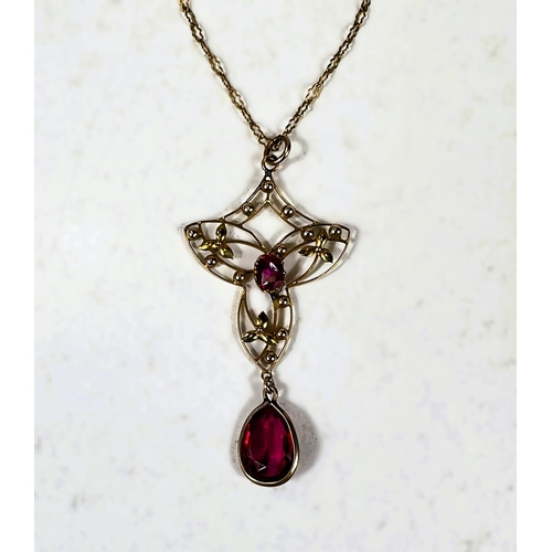 685 - An Art Nouveau style yellow metal pendant stamped 9ct, with central ruby and ruby colour drop, on fi... 