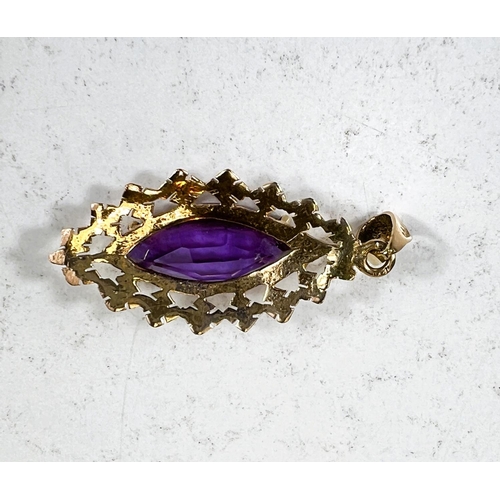 687 - A marquise cut purple / red amethyst stone set in yellow metal pendant stamped 18ct, length of stone... 