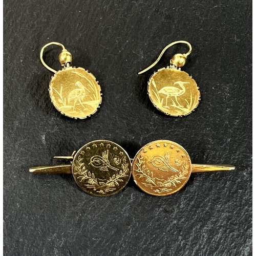 690 - A pair of earrings formed from gold coloured coins and a similar bar brooch, all test as 18ct, gross... 