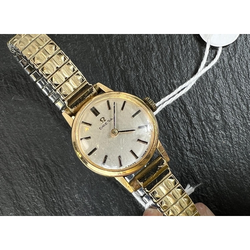 698 - An Omega ladies gold plated wristwatch on expanding bracelet.