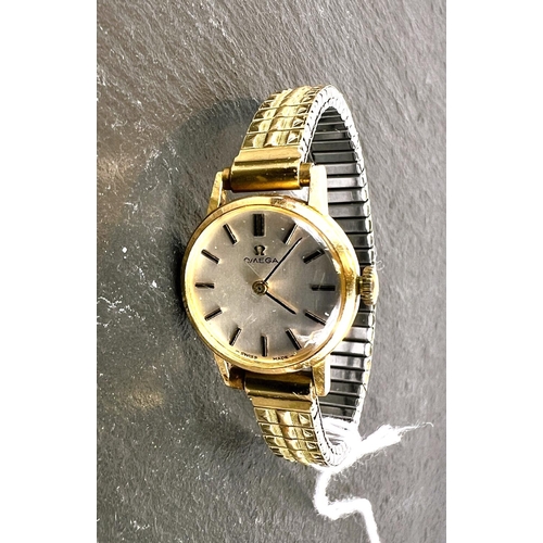 698 - An Omega ladies gold plated wristwatch on expanding bracelet.