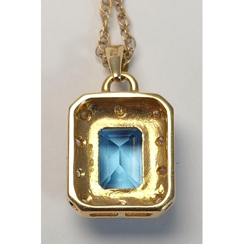 718 - A canted rectangular pendant set with a central cushion cut blue topaz surrounded by illusion set di... 