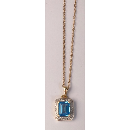 718 - A canted rectangular pendant set with a central cushion cut blue topaz surrounded by illusion set di... 