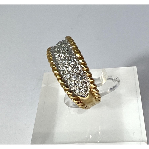 722 - A 9 carat hallmarked gold dress ring with multiple clear stones in split shank setting with rope twi... 