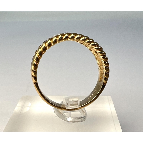 722 - A 9 carat hallmarked gold dress ring with multiple clear stones in split shank setting with rope twi... 