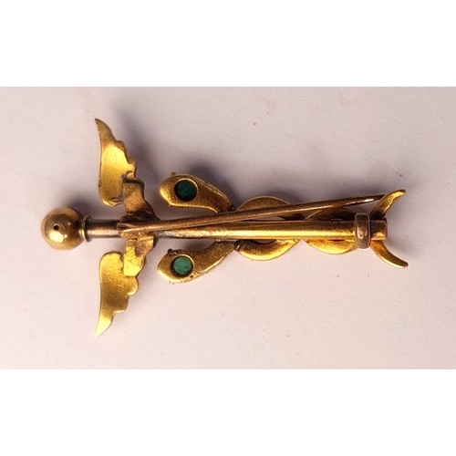 786 - A yellow metal Caduceus brooch set 2 emeralds, enamelled finial, (tests 14ct) base metal pin. 3.74gm... 