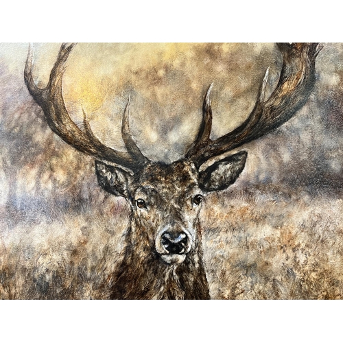 841 - Gary Benfield (British Contemporary) large oil on board of a full Stag standing in long grass signed... 