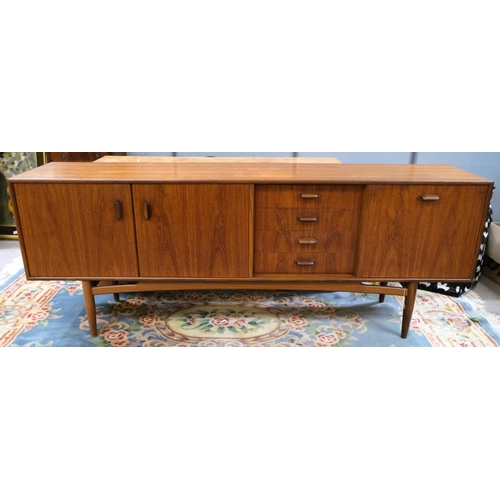 852 - A mid 20th century G-Plan 'Brasilia' teak long low sideboard with double cupboard and four drawers, ... 