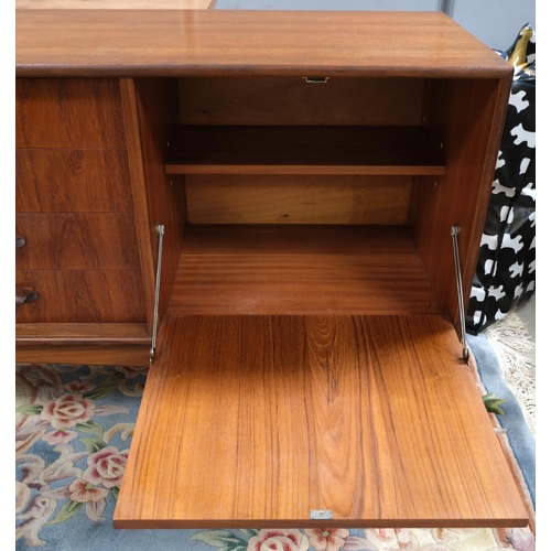 852 - A mid 20th century G-Plan 'Brasilia' teak long low sideboard with double cupboard and four drawers, ... 