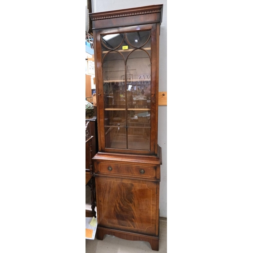 885 - A narrow reproduction mahogany full height display cabinet enclosed by glazed and one panelled door