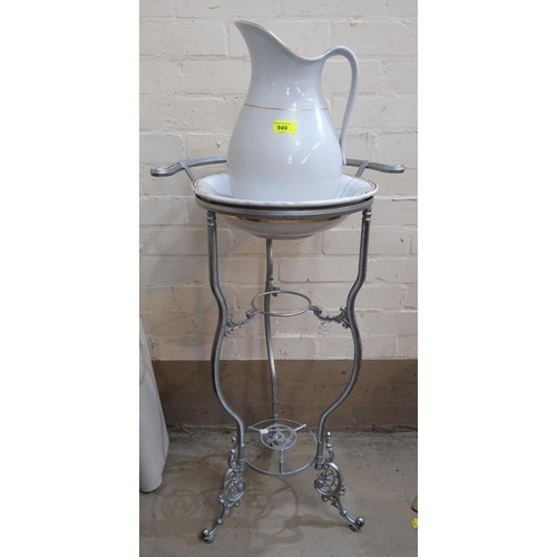 949 - A continental vintage style cast metal washstand, height 81cm; a china jug and bowl