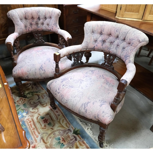 966 - A pair of Edwardian tub shaped armchairs in patterned pink fabric.