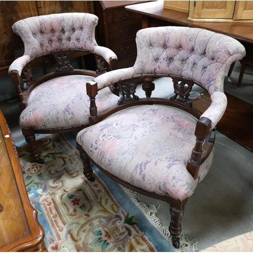 966 - A pair of Edwardian tub shaped armchairs in patterned pink fabric.