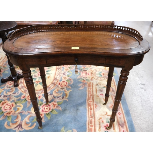 967 - A Victorian kidney shaped side table with gallery, drawer and turned legs.