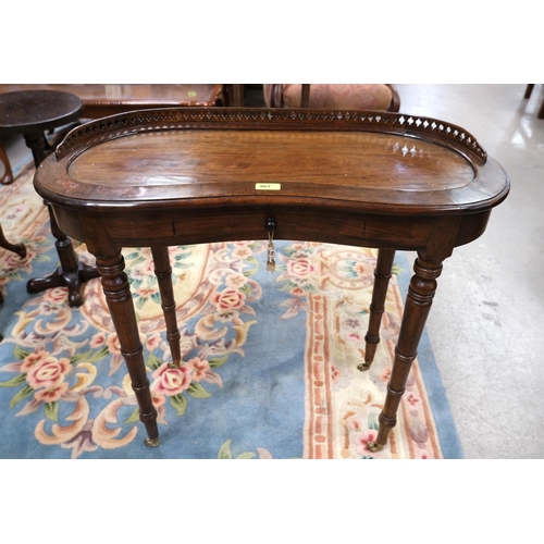 967 - A Victorian kidney shaped side table with gallery, drawer and turned legs.