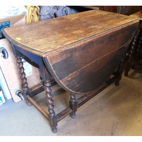 988 - An oak drop leaf barley twist table, length 106cm and 2 dining chairs