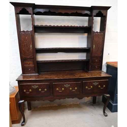 991 - An 18th/19th century oak dresser with 3 drawers below, rack and cupboards above with spice drawers