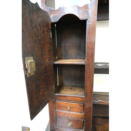 991 - An 18th/19th century oak dresser with 3 drawers below, rack and cupboards above with spice drawers