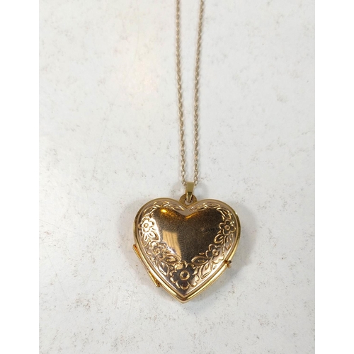 703 - A 9ct gold heart shaped photo locket on fine chain stamped 9K, 3.8gm