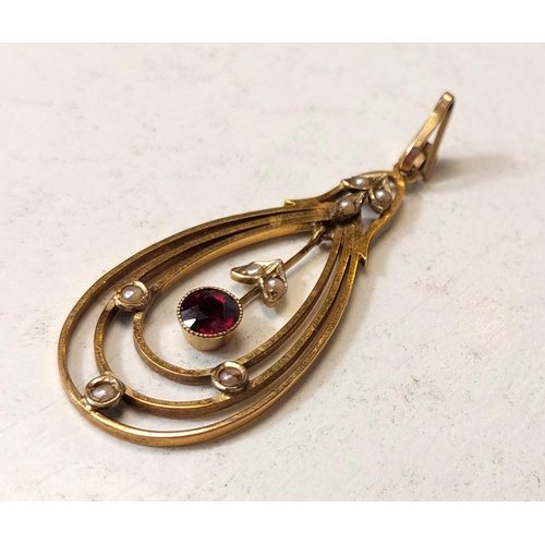 705 - An Edwardian 9ct gold oval openwork pendant set garnet and seed pearls, 2.7gm