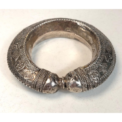 699 - AFRICAN TRIBAL BANGLE, 19th century white metal with applied decoration