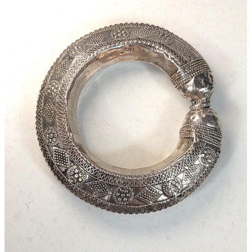 699 - AFRICAN TRIBAL BANGLE, 19th century white metal with applied decoration