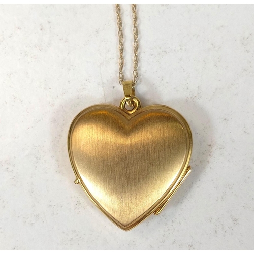 703 - A 9ct gold heart shaped photo locket on fine chain stamped 9K, 3.8gm