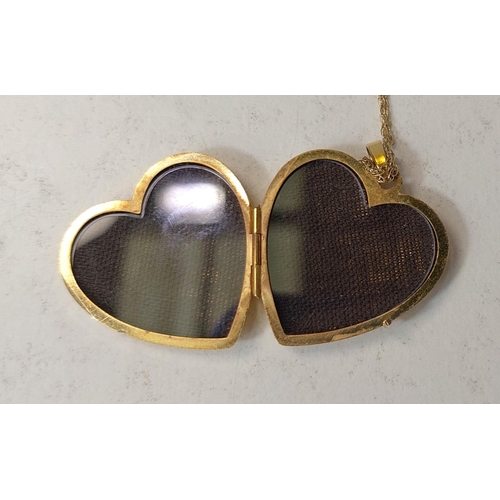 703 - A 9ct gold heart shaped photo locket on fine chain stamped 9K, 3.8gm