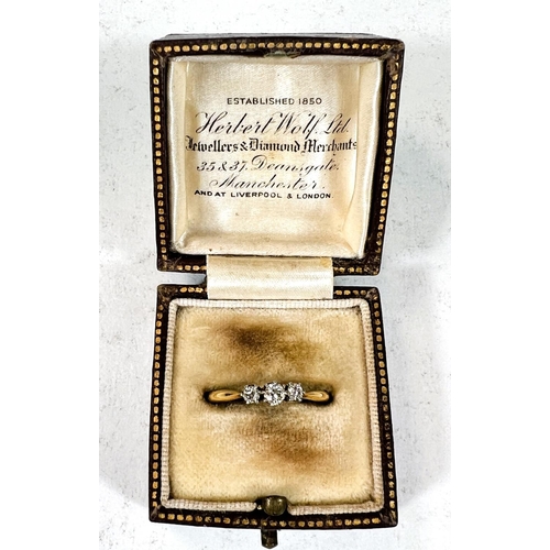 711 - An 18ct gold three stone diamond ring set with three diamonds, stamped