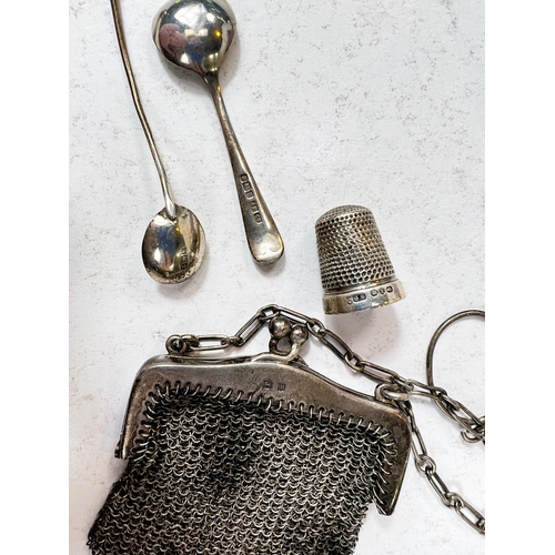 742 - A hallmarked silver small mesh purse, 2 silver salt spoons and a thimble, a Vogue powder compact, to... 